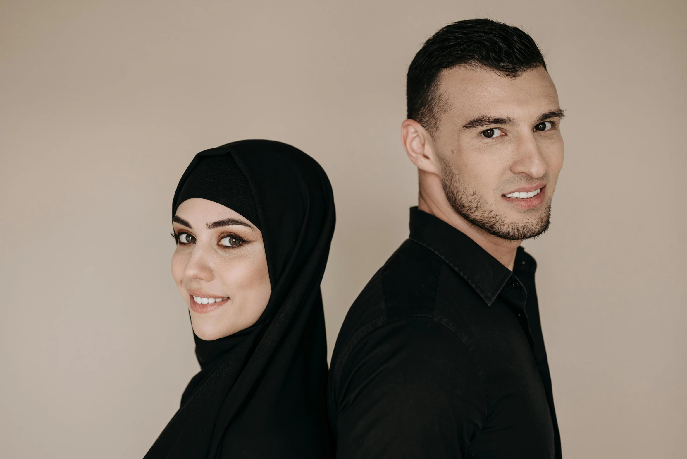 man and woman dressed in black posing for po