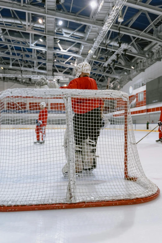 hockey players are training in an indoor rink