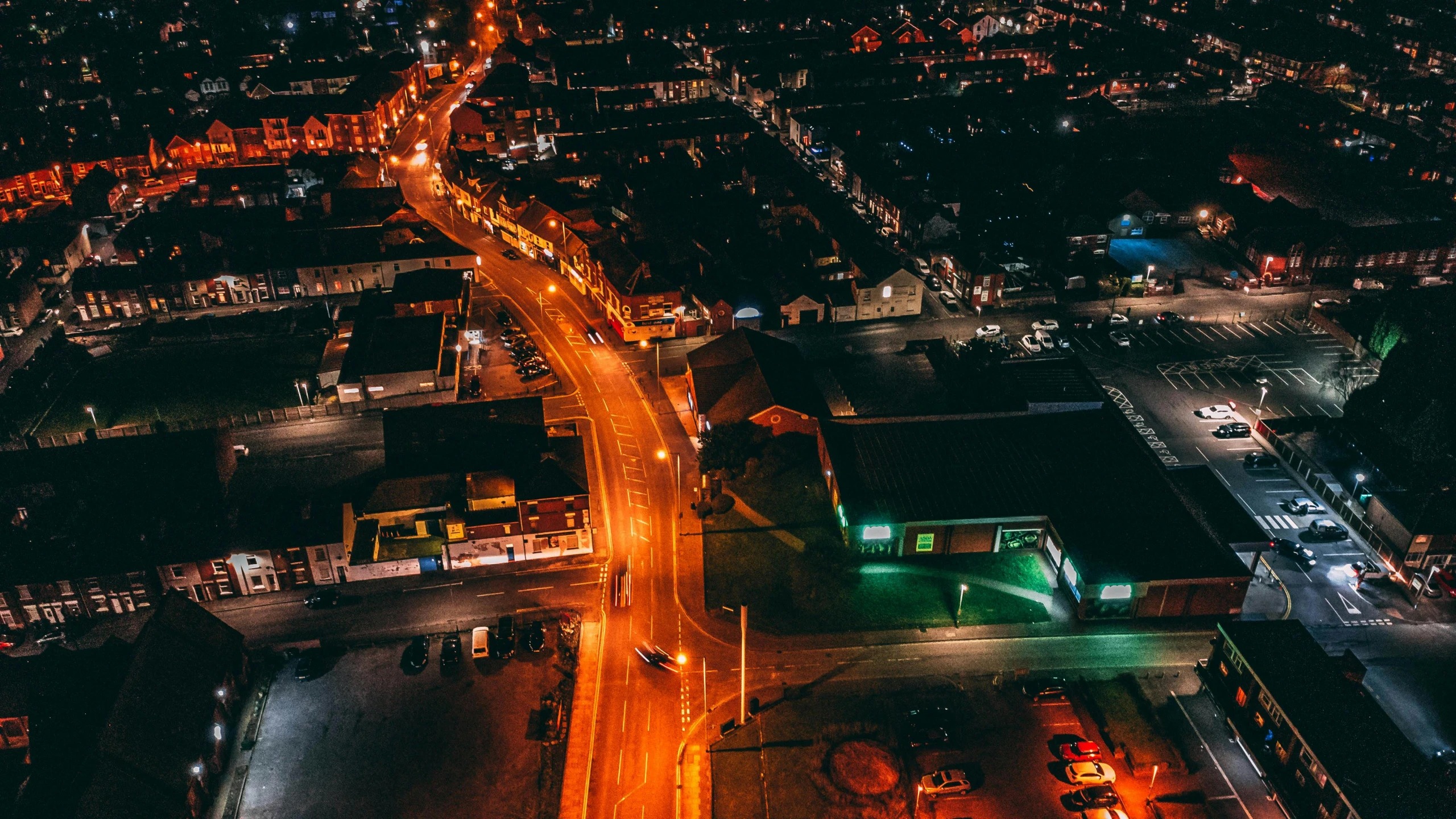 aerial view of a city at night with a large building