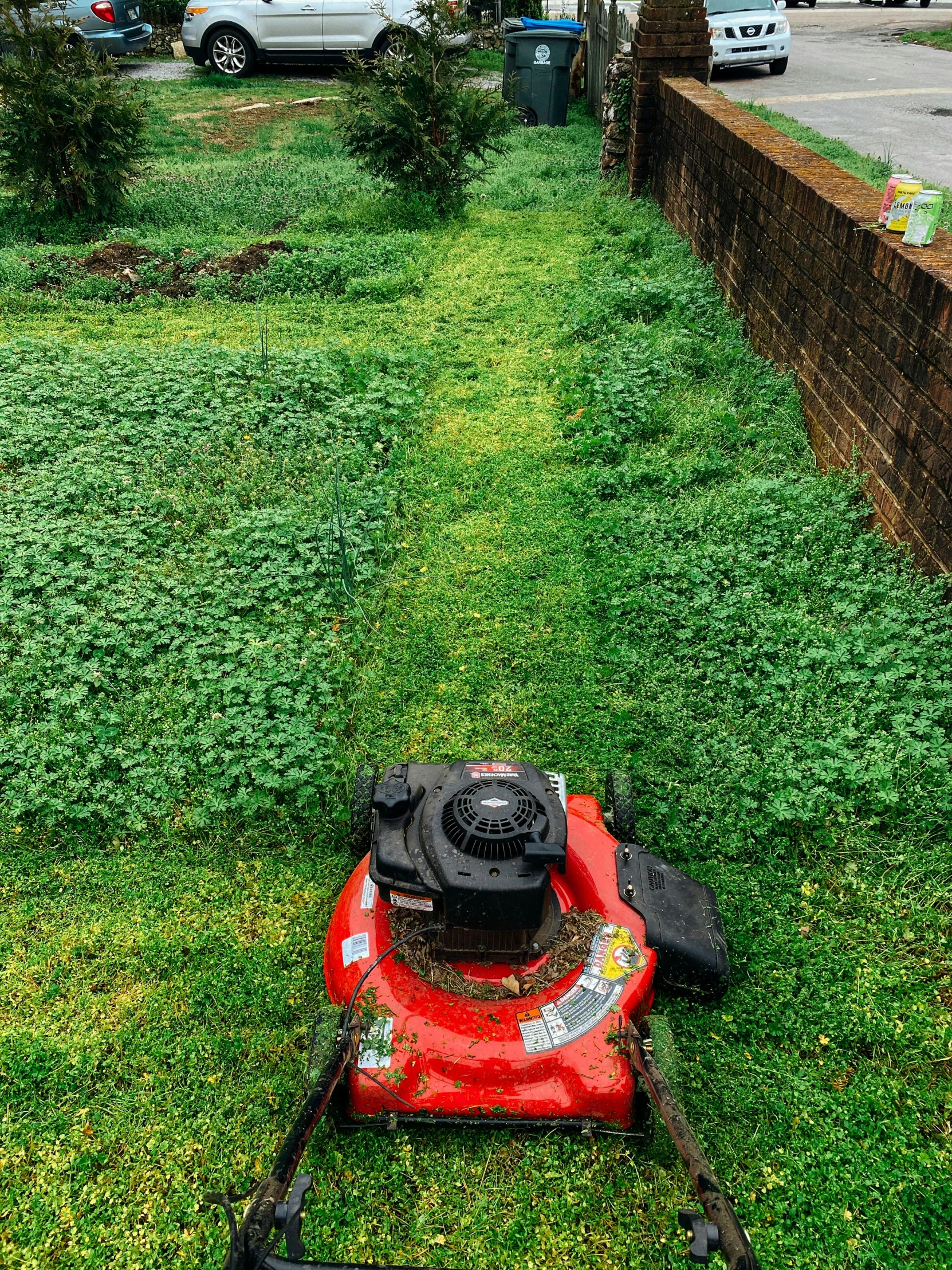 a red lawn mower sitting on top of a lush green field