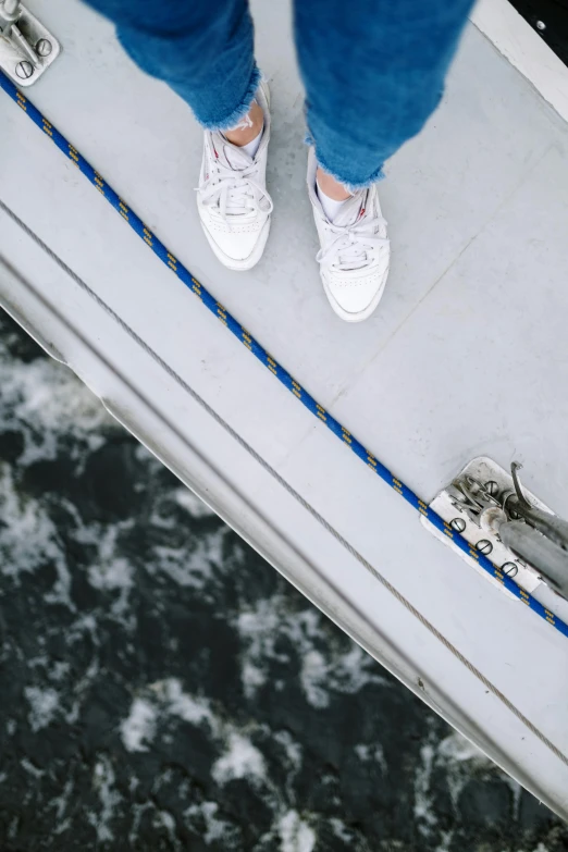 the shoes of a person standing on top of a snowboard