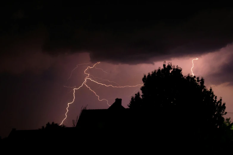 some lightning is in the sky over a building