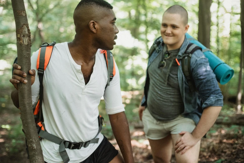 two guys walking in the woods with backpacks