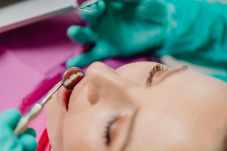 a woman getting her eyebrows checked by a dental hygienist