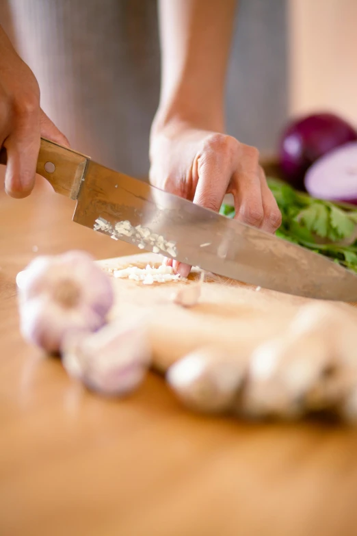 a person chopping onions with a big knife