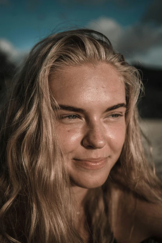 a woman smiles in an outdoor s while posing for a po