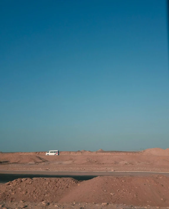 the van is parked in the middle of the desert