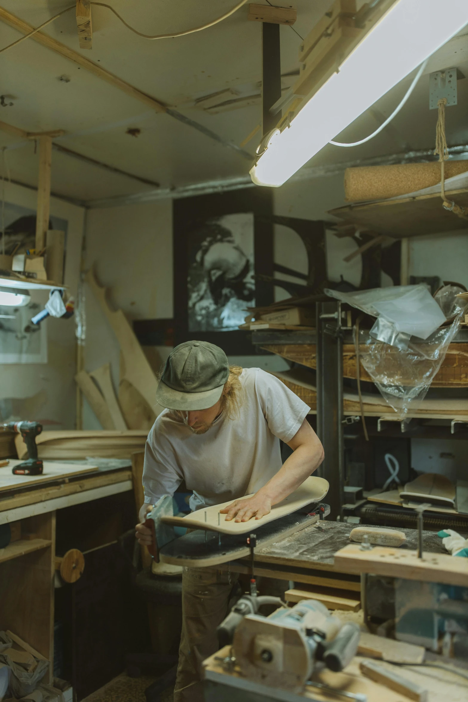 a man working on a piece of wood with a hand drill