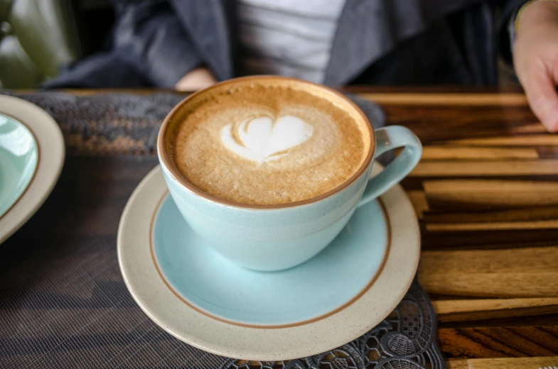 an espresso cup is shown on a plate