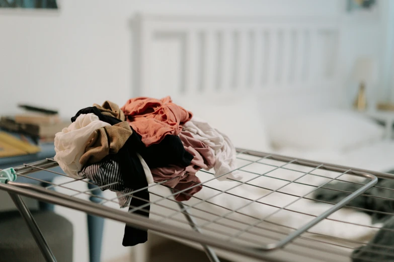 clothes on metal racks in a room