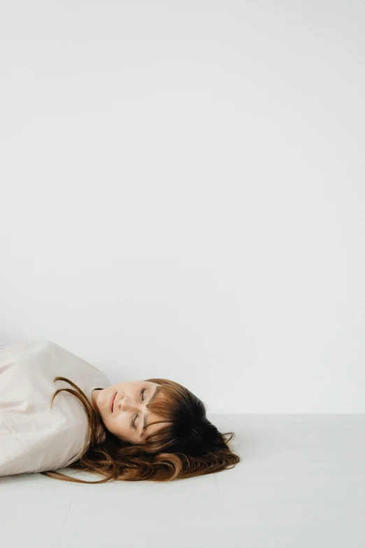 a woman lying on the ground while taking a selfie