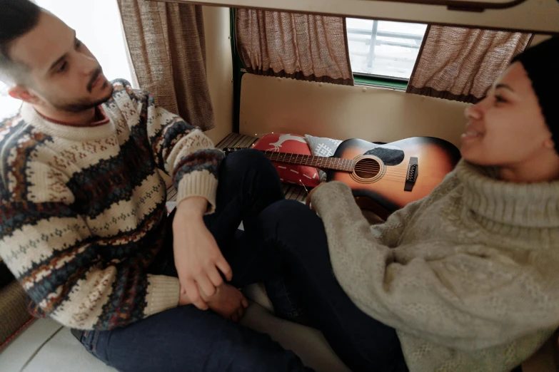 a man and woman sitting on the coach