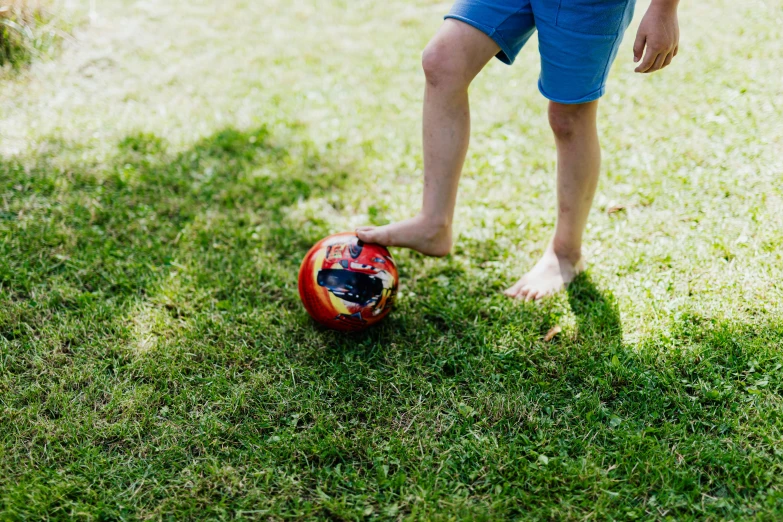 a small boy is playing with a soccer ball