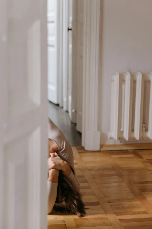 a woman is laying down on the floor and covering her eyes