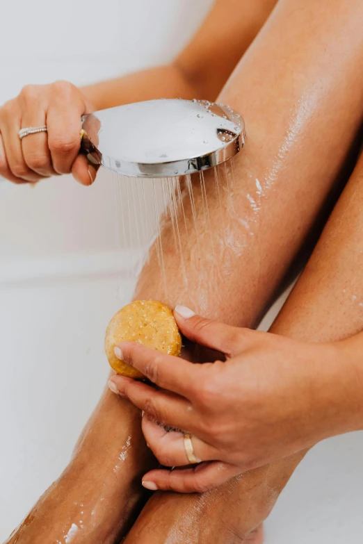 the woman has her hand under the faucet and the water runs down