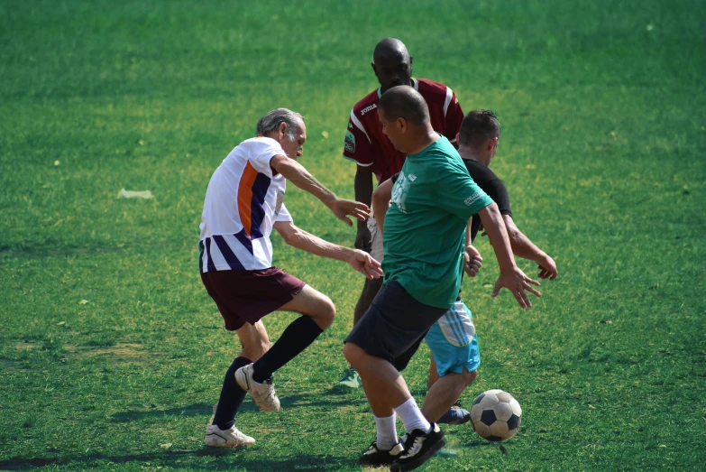 two soccer players fighting for the ball in the grass
