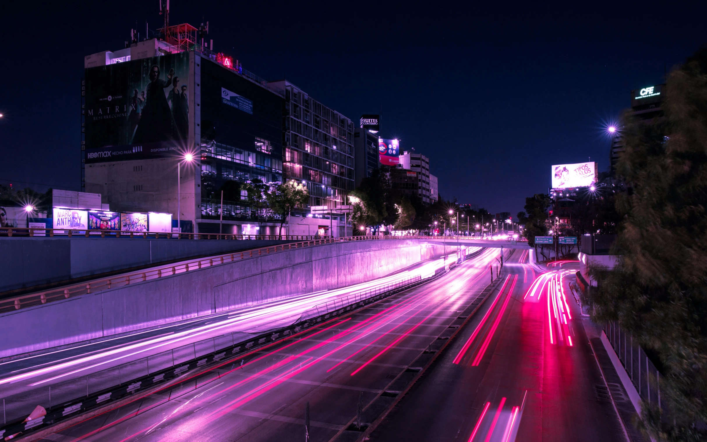 a night time picture of a street light and buildings