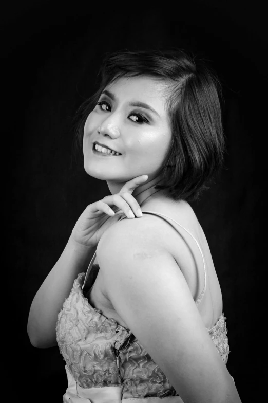 woman in dress posing for black and white pograph