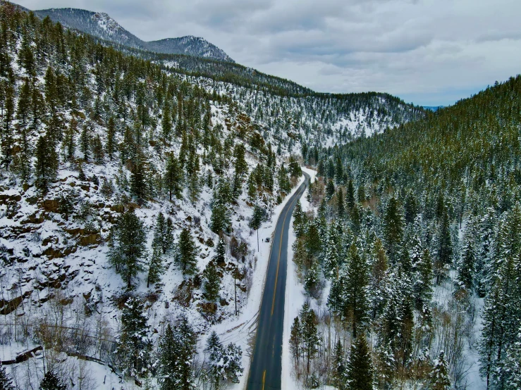 a wide view of a large snowy mountain with trees and hills in the background