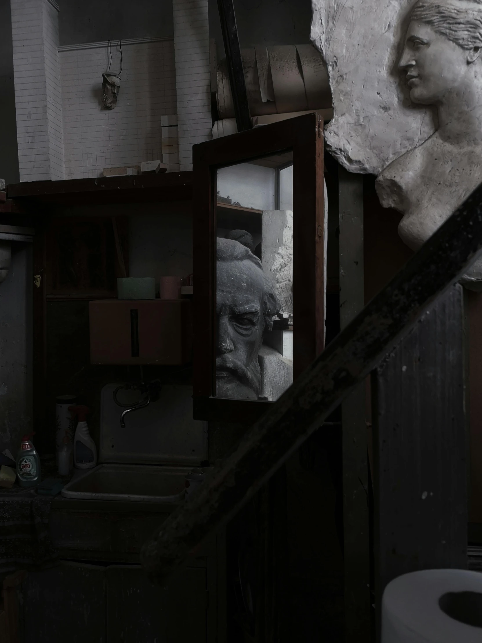 a very dirty bathroom with a statue in the corner