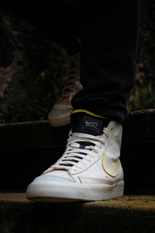 a man's shoes with gold details on them