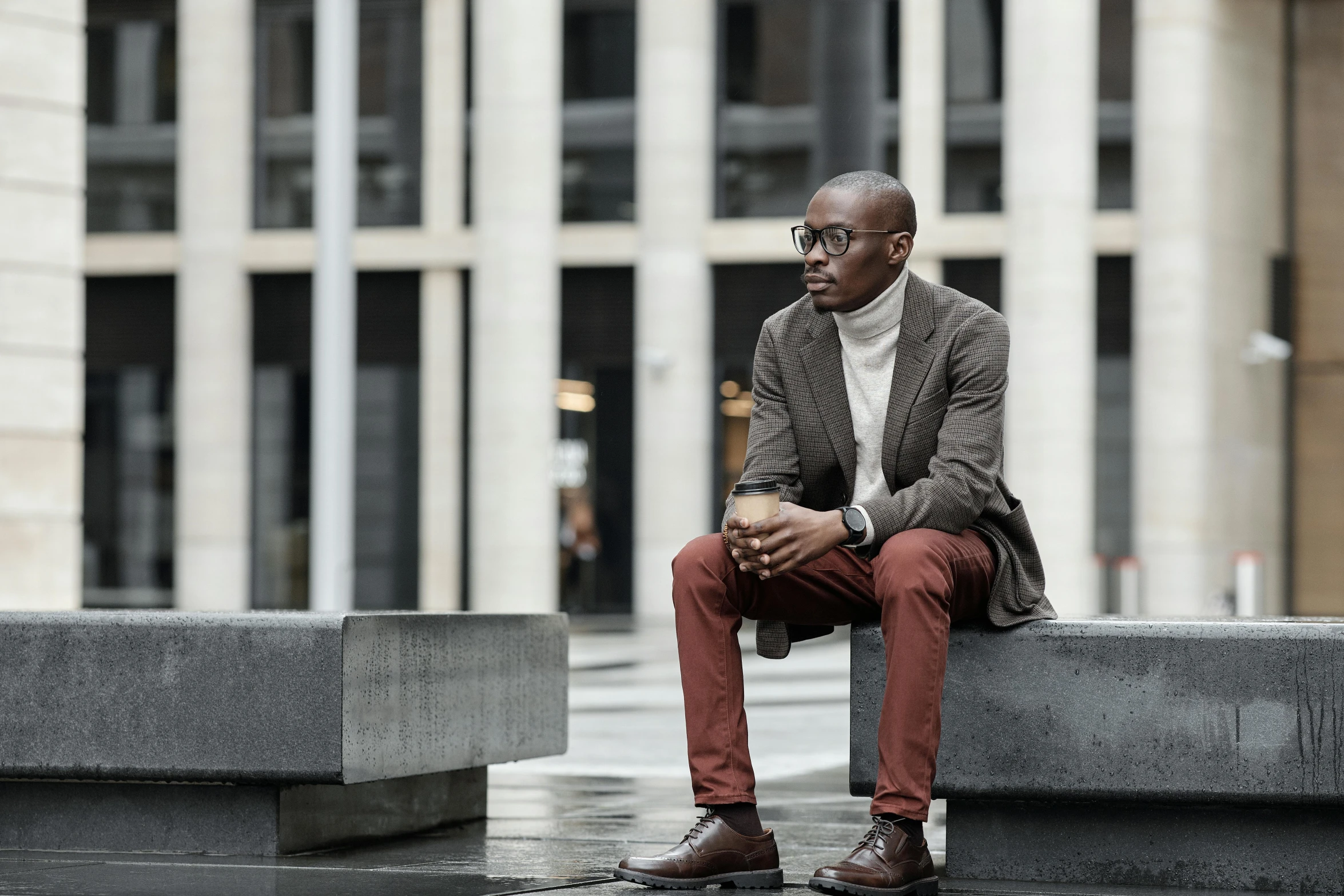 a man sitting down with his head down