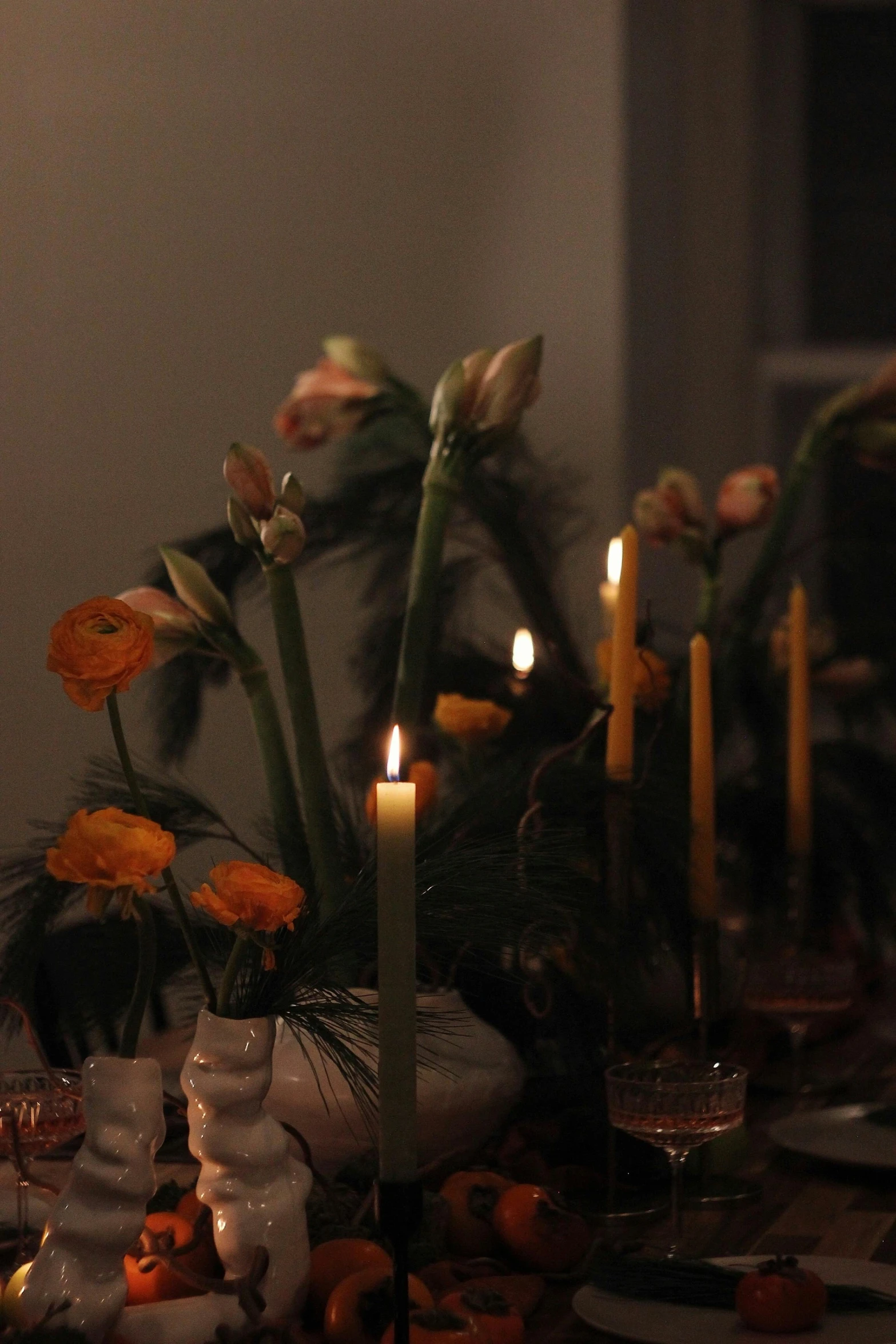 a bunch of flowers in a white vase on a table