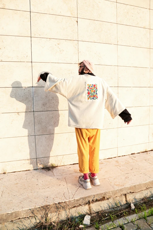 the back of a person in yellow sweatpants and a sweatshirt