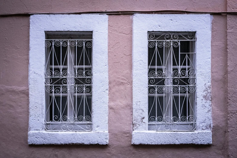 the windows are made of brick and wrought iron