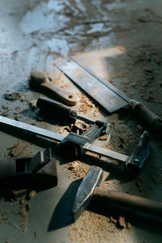 a number of knives on top of a table near a knife blade