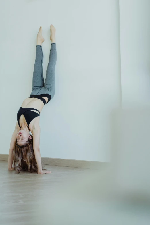 the woman is doing exercises on her handstand