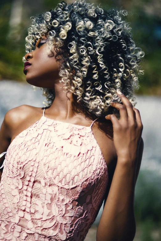 a beautiful black woman with curly hair posing