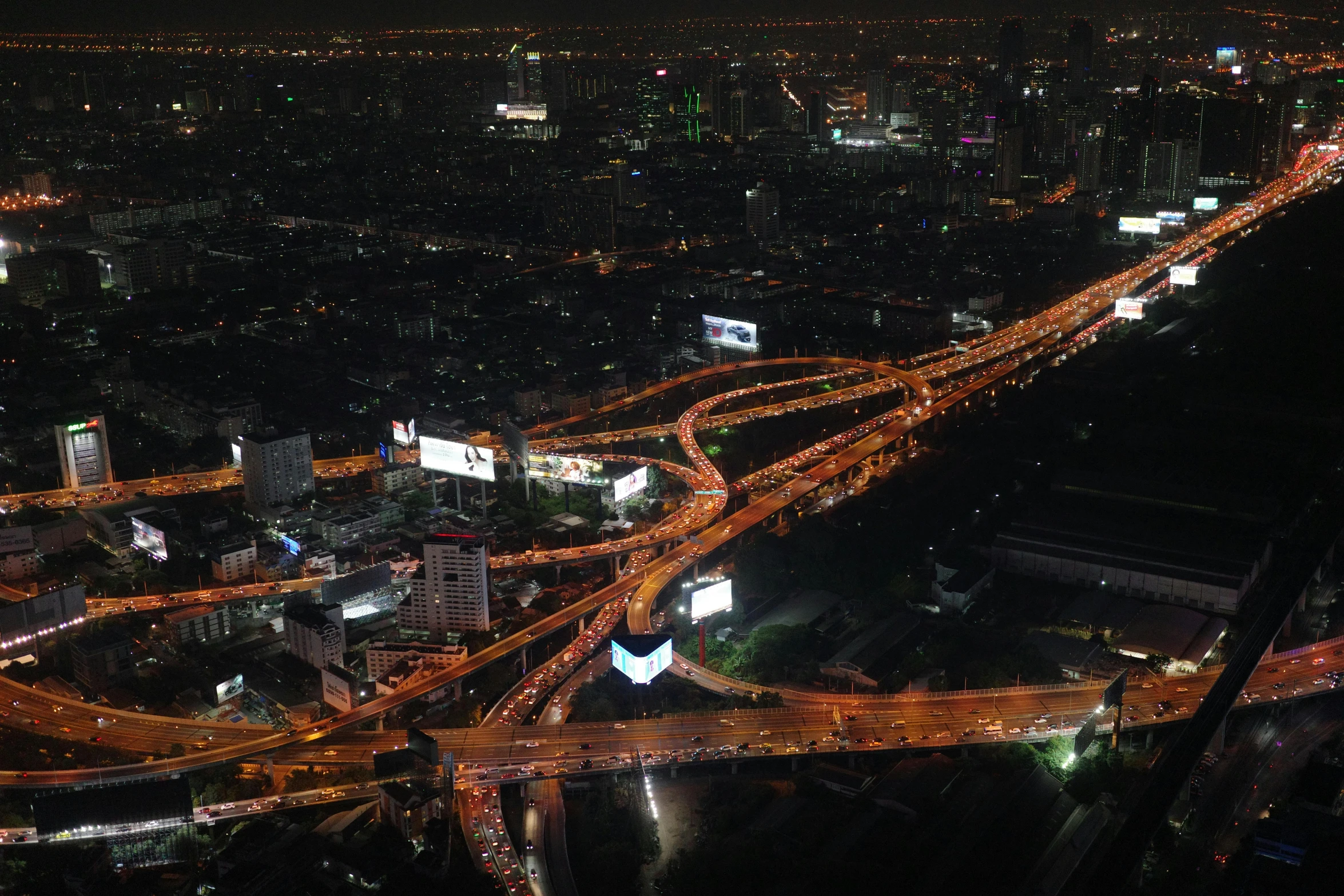 city lights are all lit up over the highway