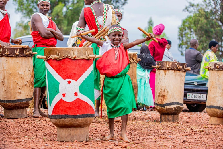 a group of people in africa standing around drums