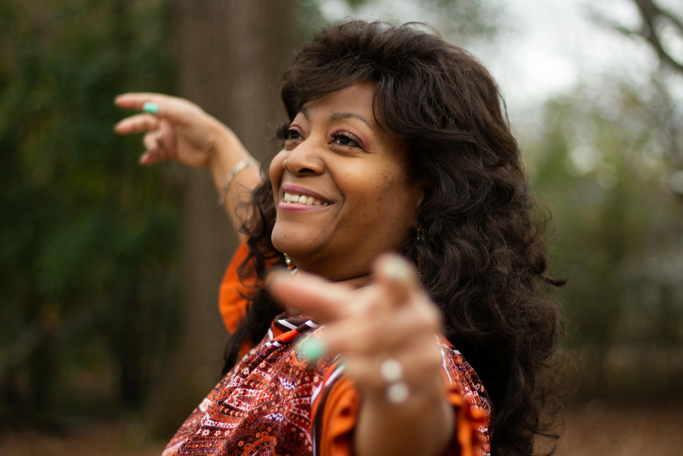 an older woman pointing out her hand outside