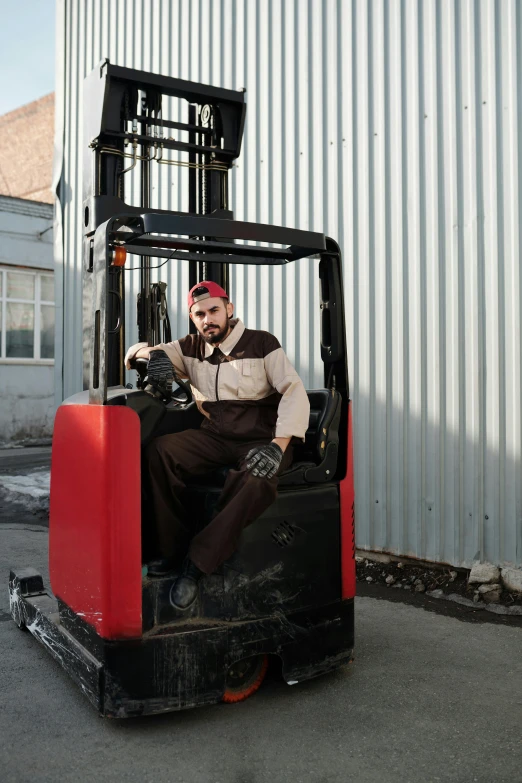 a man in white shirt sitting in a forklift