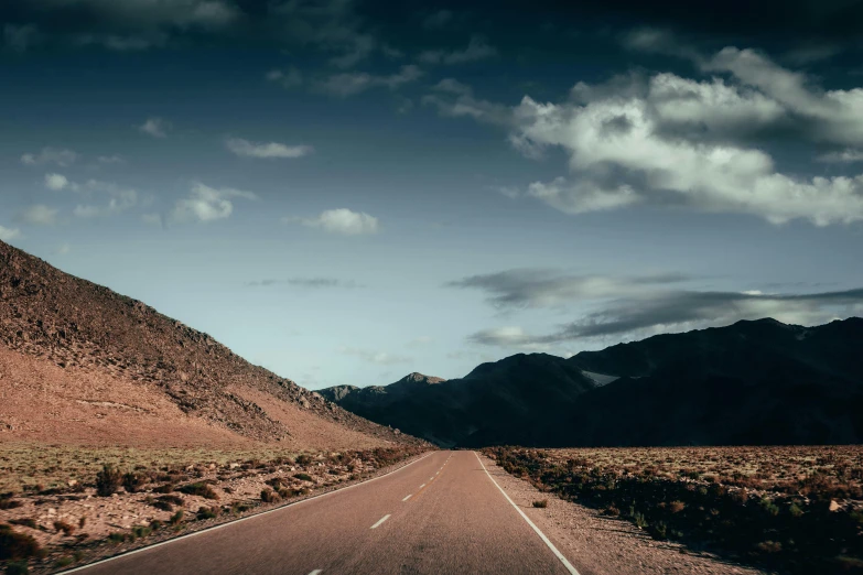 a desert road leading up the side of a mountain