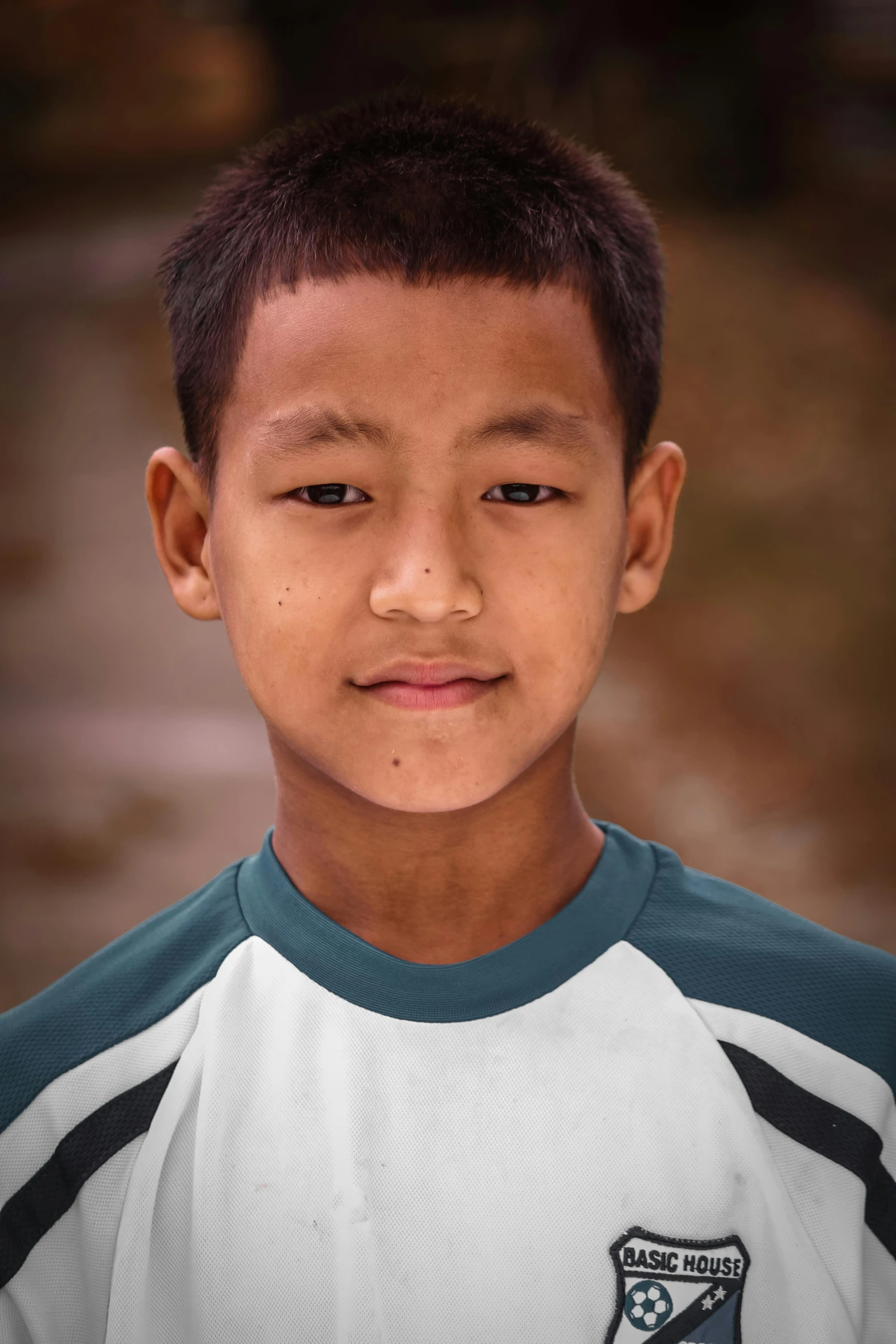 an asian boy with a green and white uniform