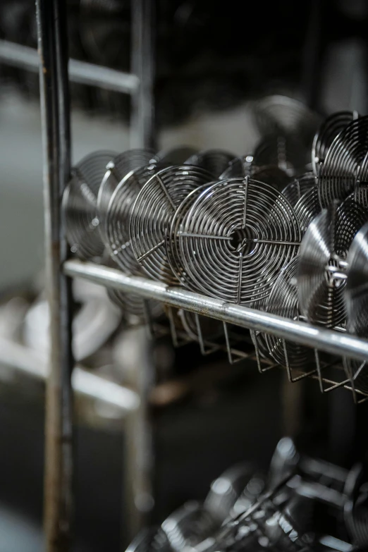 a rack filled with lots of metal bowls