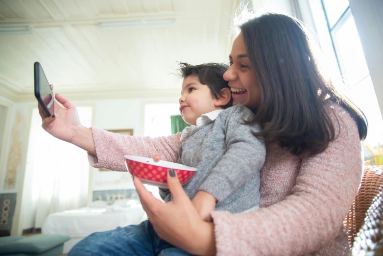 an image of woman and child playing a video game