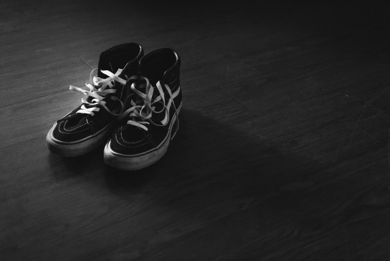 an image of pair of shoes on a dark floor