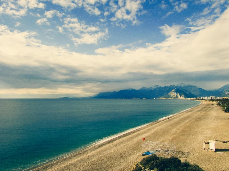 a beach with a pier next to a lake