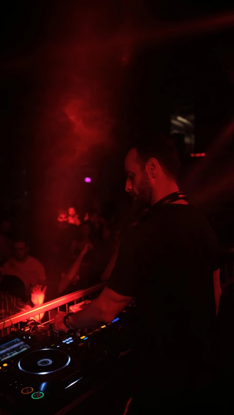 dj playing at a party in the dark