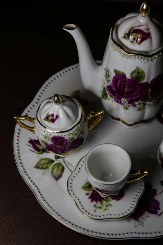 a floral tea set sitting on top of a plate