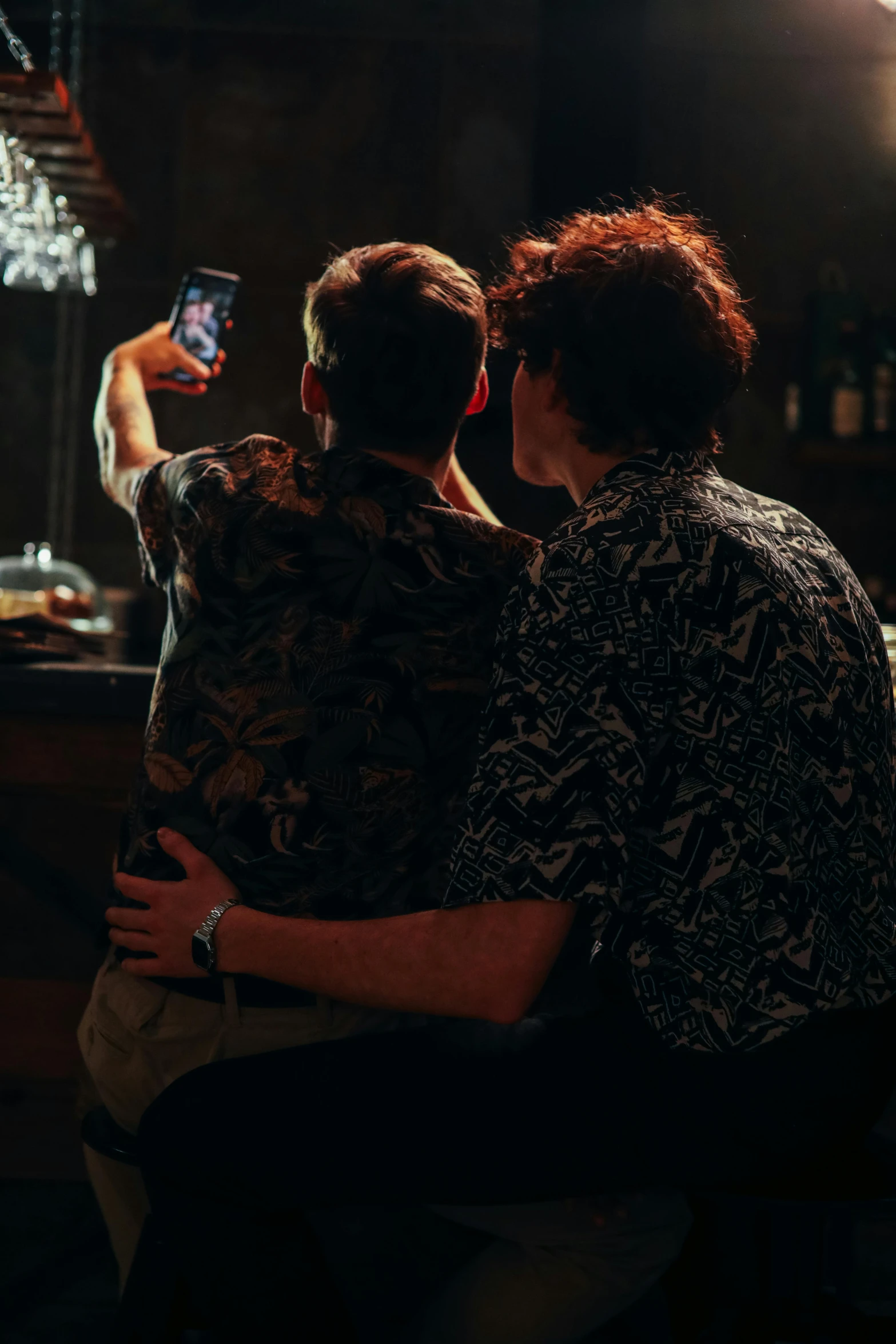 a woman and a man take a picture in front of the bar