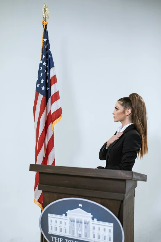 the state department secretary is sitting at her podium