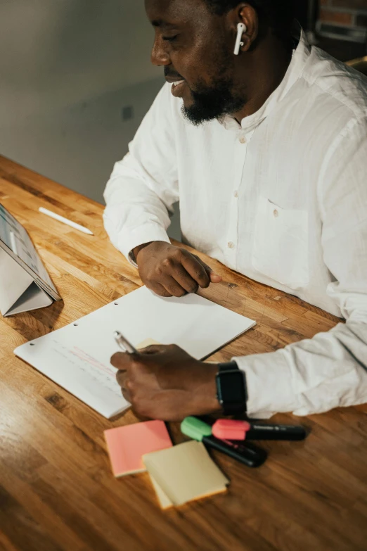 a man in white shirt sitting at a table