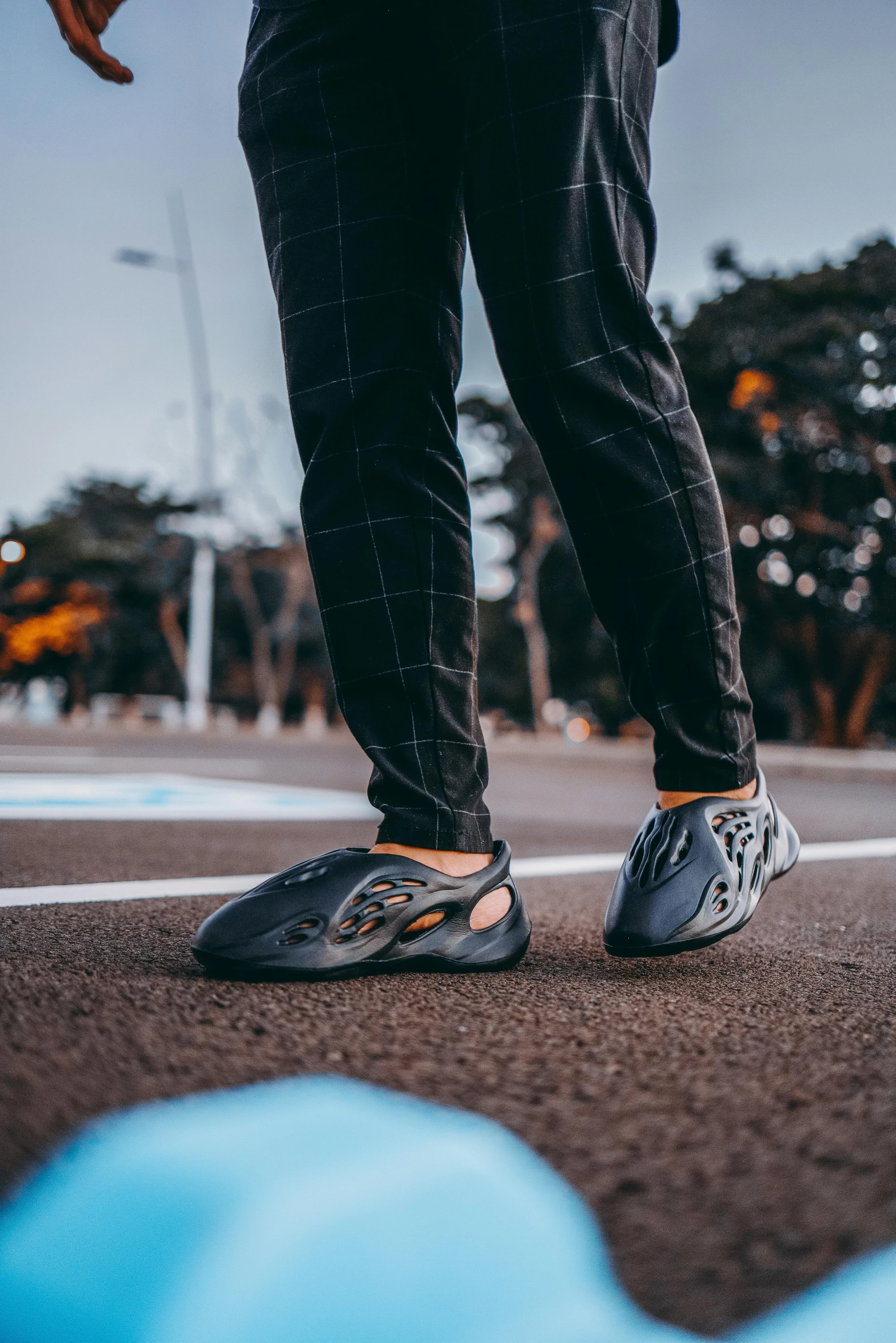 man with feet up on a street curb