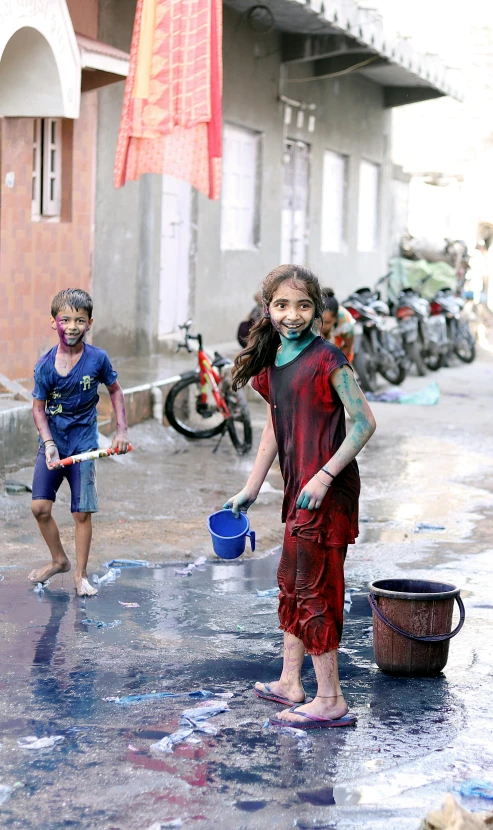 two small children are playing in the water