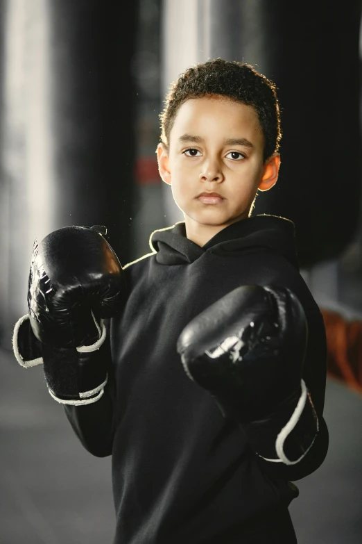  holding black gloves looking at camera